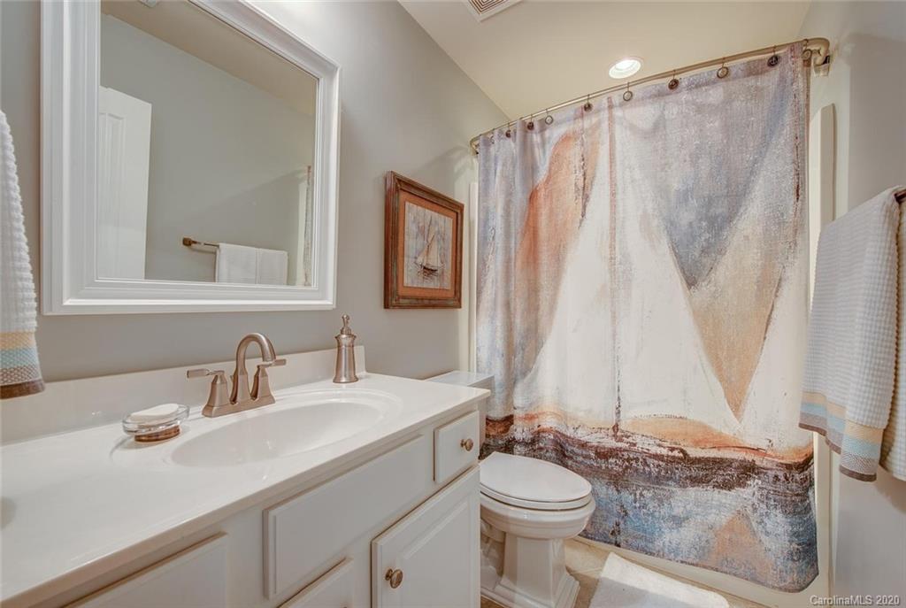220 Falling Ridge, Unit 149 Mount Holly, NC 28012 - Photo 16 of 19 a bathroom with a granite countertop sink toilet and shower