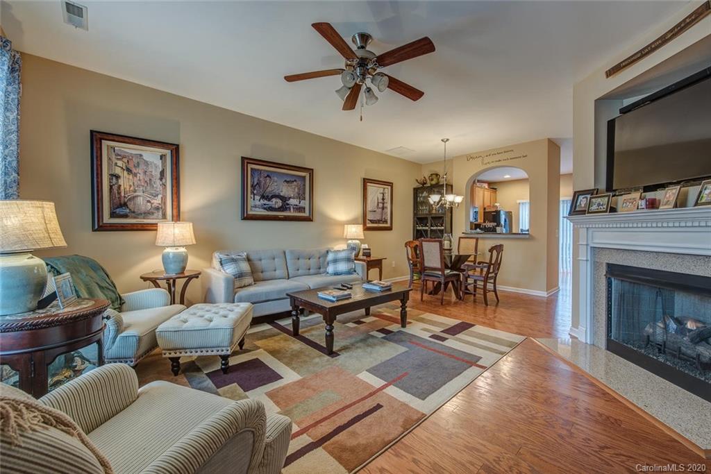 220 Falling Ridge, Unit 149 Mount Holly, NC 28012 - Photo 3 of 19 a living room with furniture a flat screen tv and a fireplace
