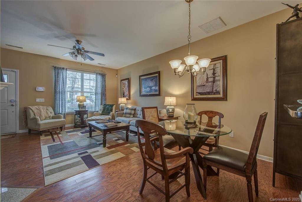 220 Falling Ridge, Unit 149 Mount Holly, NC 28012 - Photo 5 of 19 a living room with couches a dining table and chairs with wooden floor