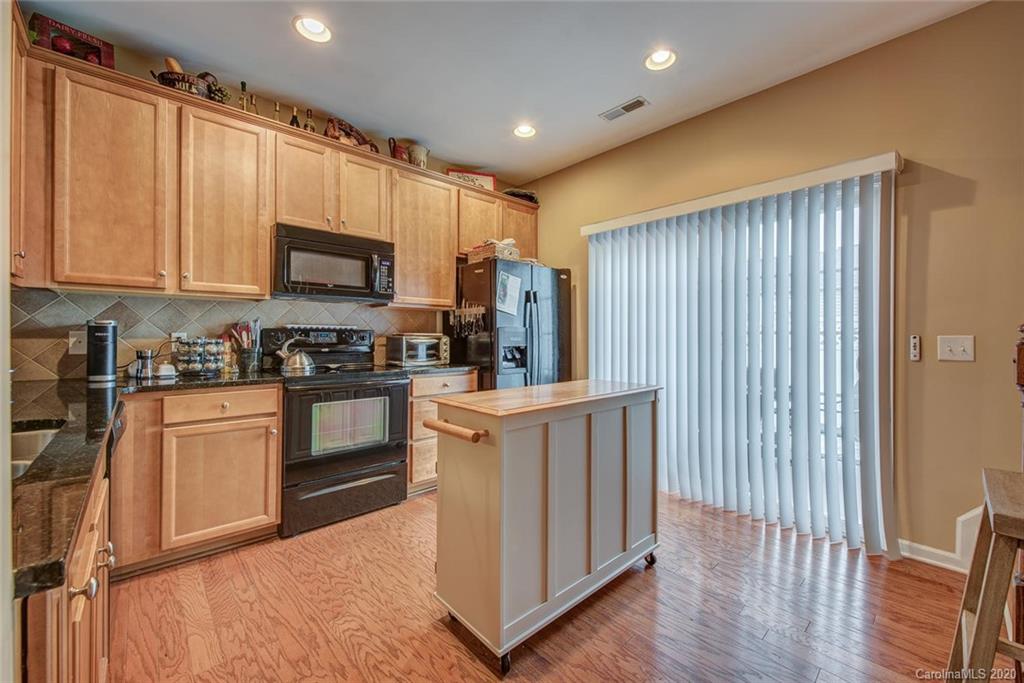 220 Falling Ridge, Unit 149 Mount Holly, NC 28012 - Photo 7 of 19 a kitchen with stainless steel appliances granite countertop a refrigerator a stove top oven a sink and dishwasher