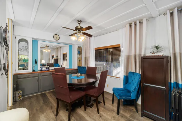 a dining room with furniture a window and a chandelier
