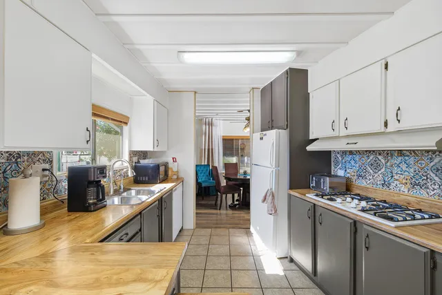 a kitchen with refrigerator and cabinets
