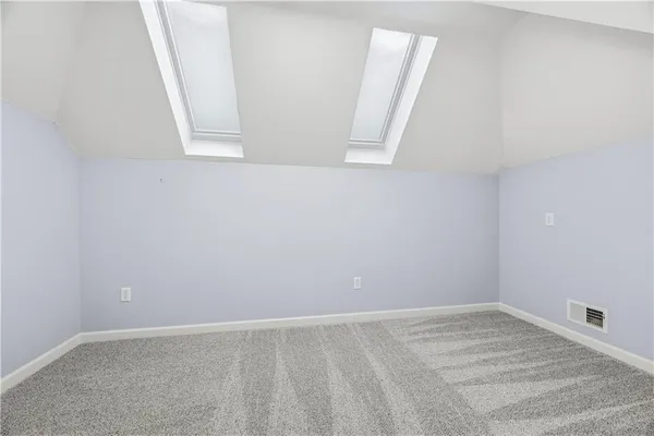 an empty room with wooden floor and furniture