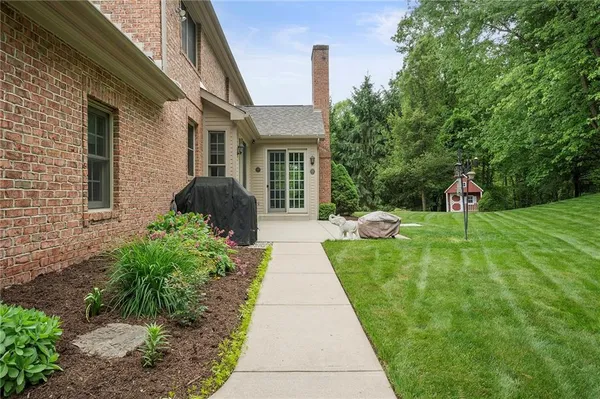 a view of a house with a garden and pathway