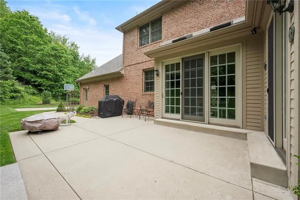 a view of backyard with barbeque grill and plants