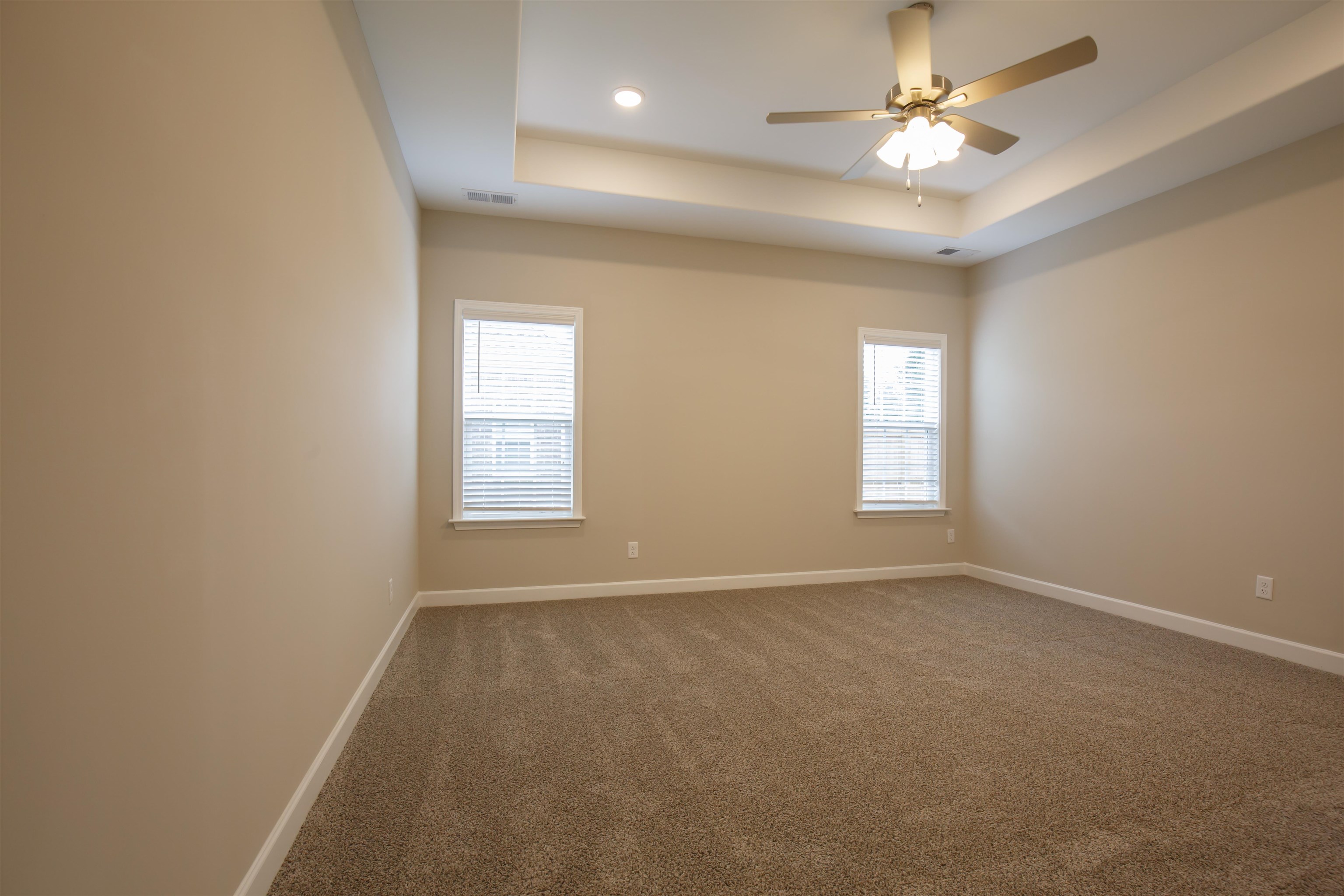 8763 Shipp Road Millington, TN 38053 - Photo 5 of 9 Spare room featuring a tray ceiling, dark carpet, visible vents, and baseboards