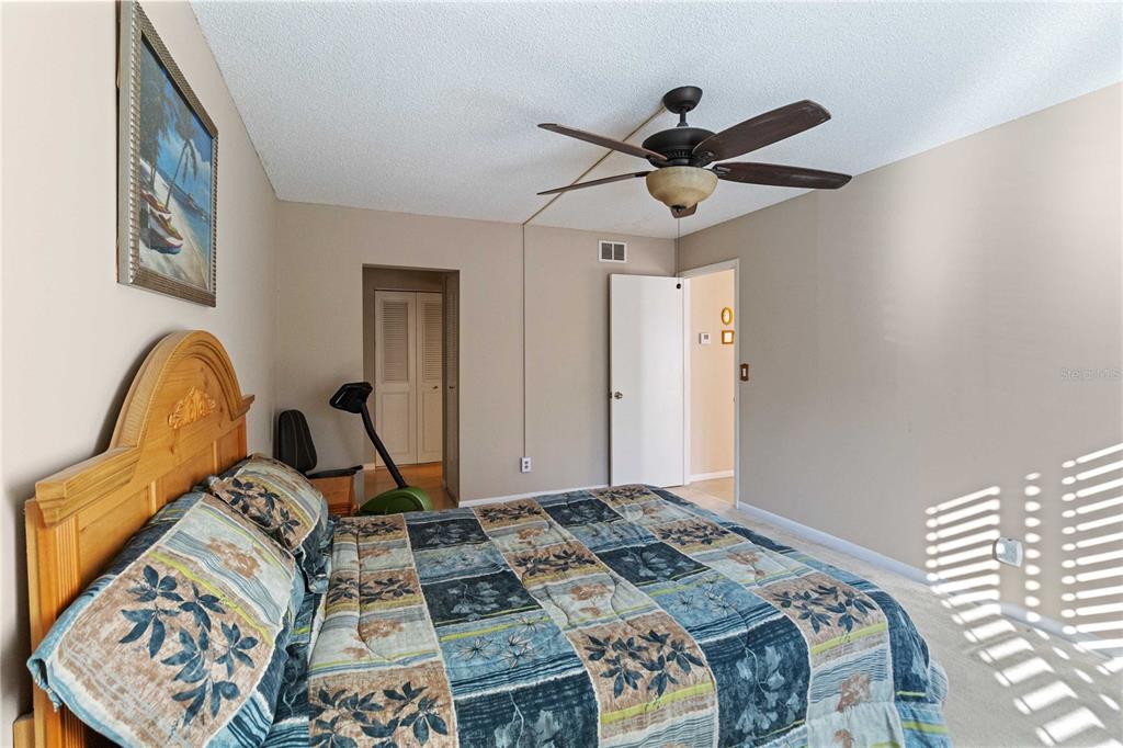 8205 Sun Spring Circle, Unit C2 Orlando, FL 32825 - Photo 13 of 18 a bedroom with a bed and a chandelier