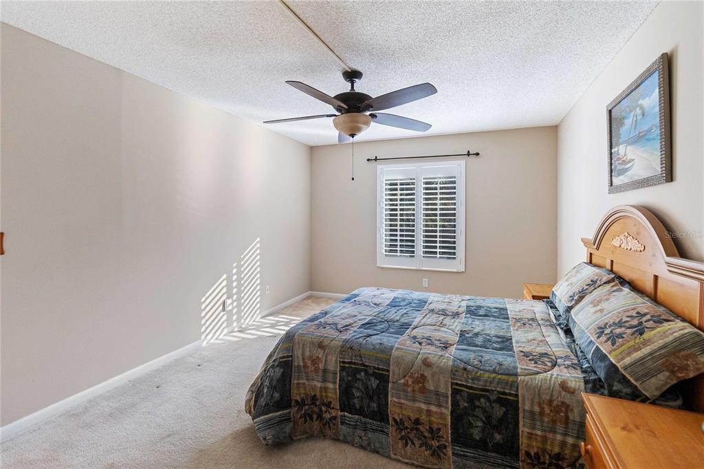 8205 Sun Spring Circle, Unit C2 Orlando, FL 32825 - Photo 14 of 18 a bedroom with a bed and a window