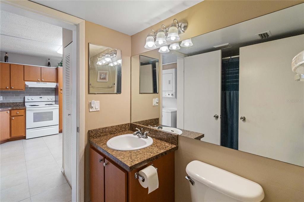8205 Sun Spring Circle, Unit C2 Orlando, FL 32825 - Photo 15 of 18 a bathroom with a sink a toilet a mirror and vanity