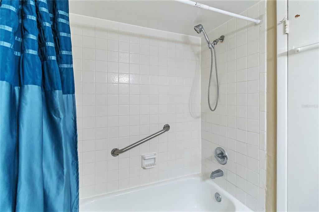 8205 Sun Spring Circle, Unit C2 Orlando, FL 32825 - Photo 16 of 18 a bathroom with a shower and a bath tub