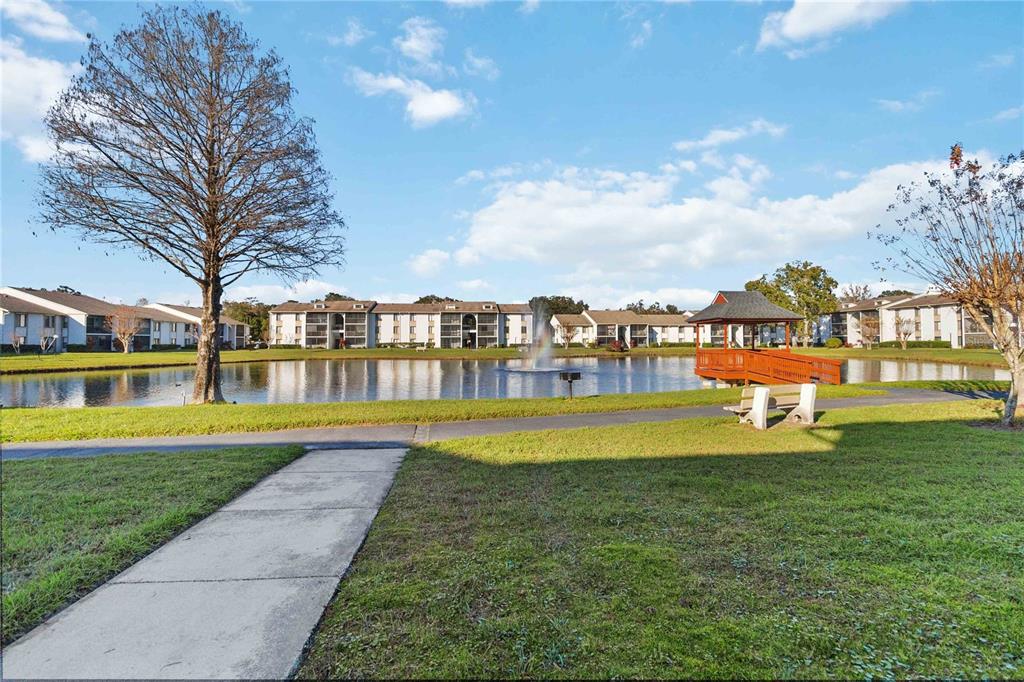 8205 Sun Spring Circle, Unit C2 Orlando, FL 32825 - Photo 2 of 18 a view of swimming pool with outdoor seating and trees in the background