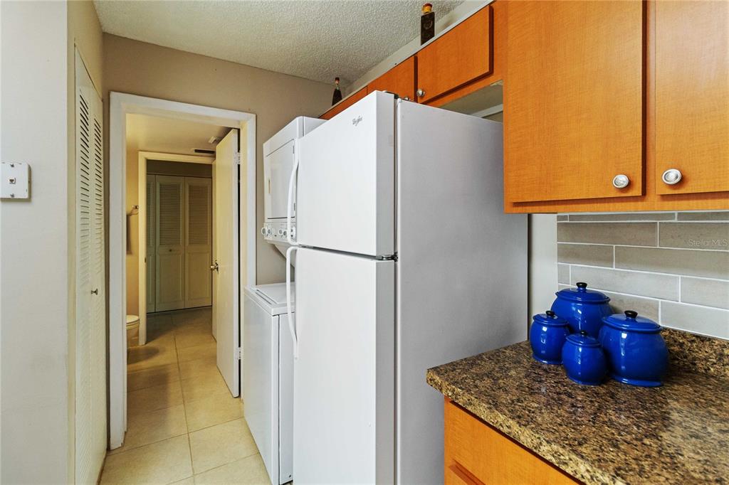 8205 Sun Spring Circle, Unit C2 Orlando, FL 32825 - Photo 8 of 18 a bathroom with a granite countertop sink and a refrigerator