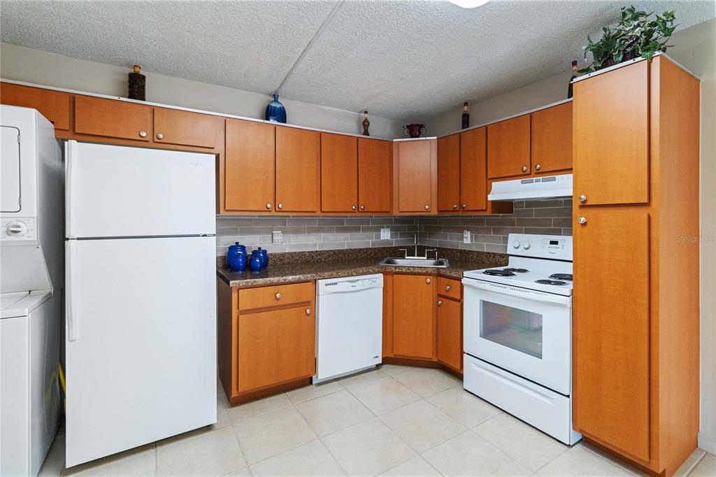 8205 Sun Spring Circle, Unit C2 Orlando, FL 32825 - Photo 10 of 18 a kitchen with stainless steel appliances granite countertop a refrigerator a stove a sink and dishwasher