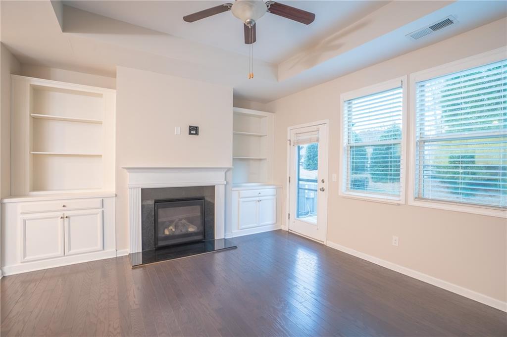 2420 Boxwalking Court Cumming, GA 30040 - Photo 12 of 42 a view of an empty room with a fireplace and a window