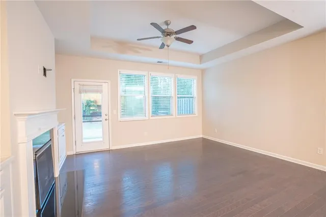 a view of an empty room with a fireplace and a window