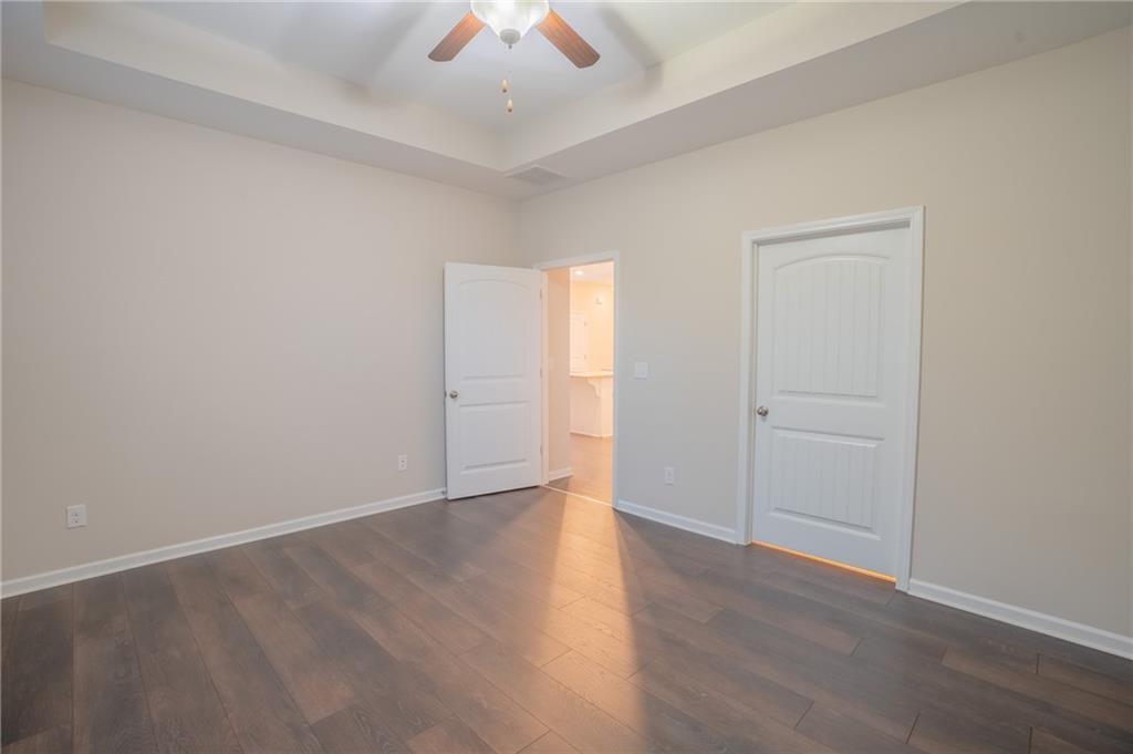 2420 Boxwalking Court Cumming, GA 30040 - Photo 20 of 42 an empty room with wooden floor and windows