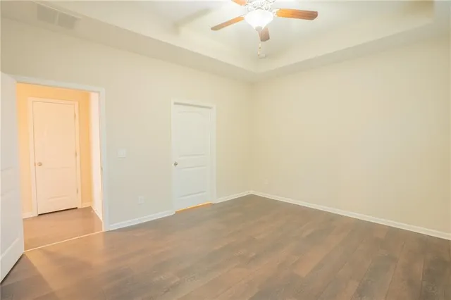 an empty room with a chandelier fan