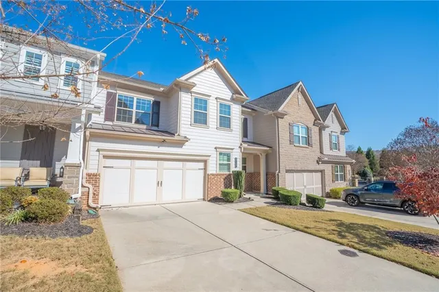 a front view of a house with a yard and garage