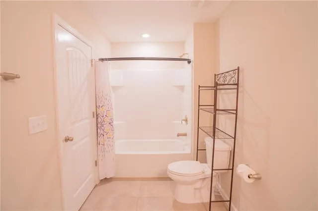 a bathroom with a shower a toilet and a shower