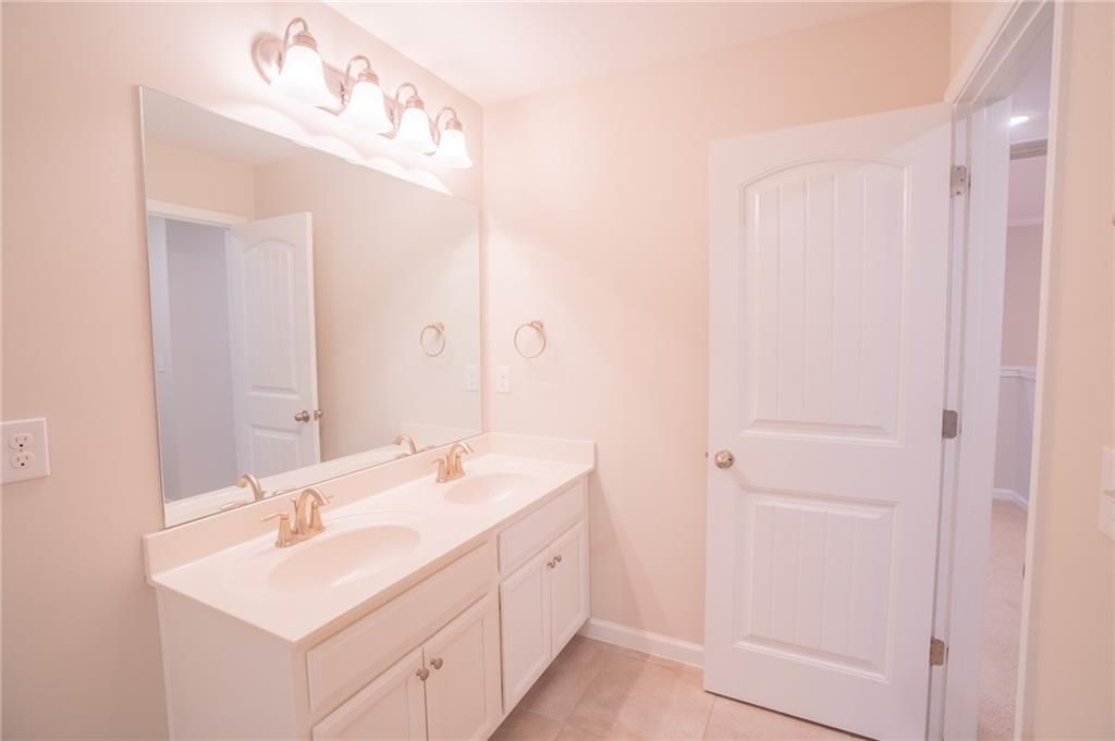 2420 Boxwalking Court Cumming, GA 30040 - Photo 36 of 42 a bathroom with a double vanity sink mirror and