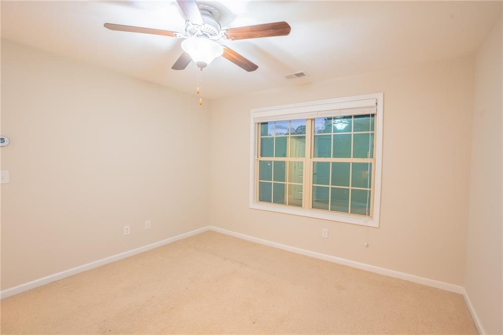 2420 Boxwalking Court Cumming, GA 30040 - Photo 37 of 42 an empty room with a window and a ceiling fan