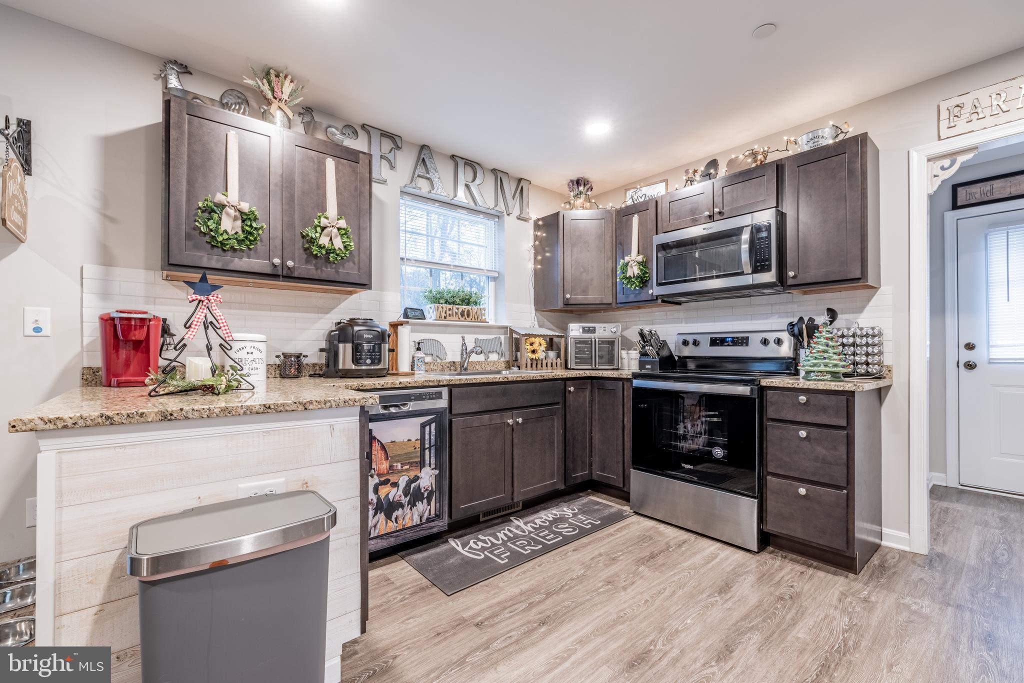111 Cee Jay Road Chestertown, MD 21620 - Photo 15 of 38 a kitchen with stainless steel appliances granite countertop a stove sink and microwave