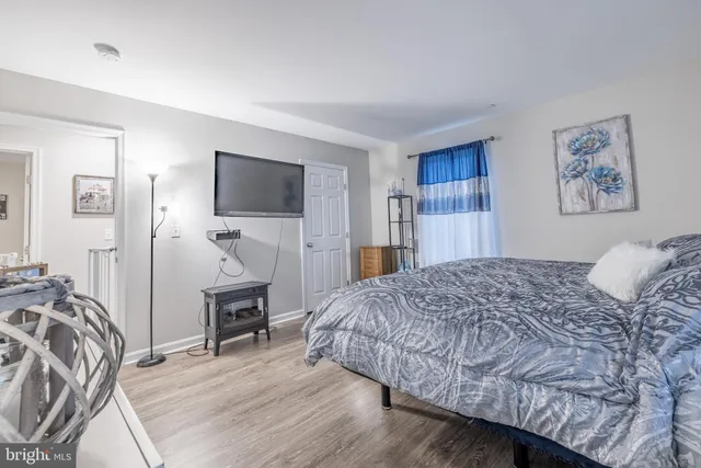 a bedroom with a large bed and a window