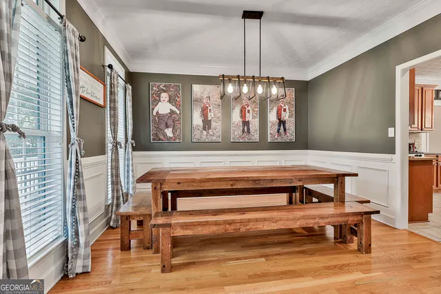 a view of a dining room with furniture window and wooden floor