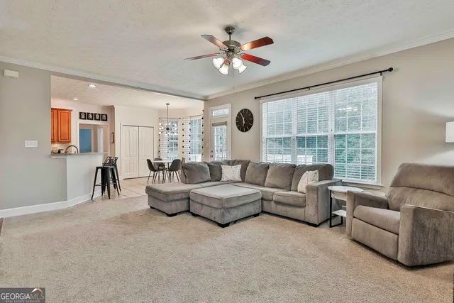a view of a dining room with furniture and chandelier