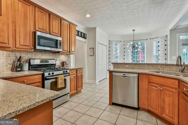 a view of a hallway to a livingroom with wooden floor and stairs