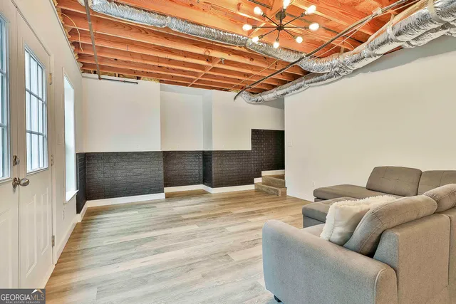 a bathroom with a granite countertop toilet sink vanity and mirror