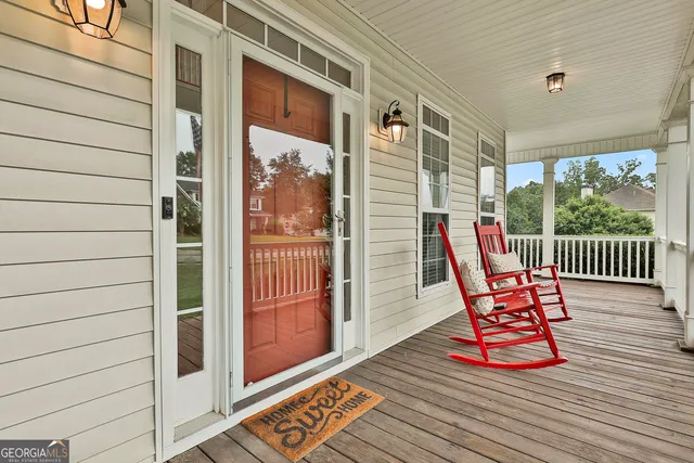 a view of a hallway view with living room and wooden floor