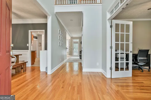 a view of empty room with wooden floor and windows