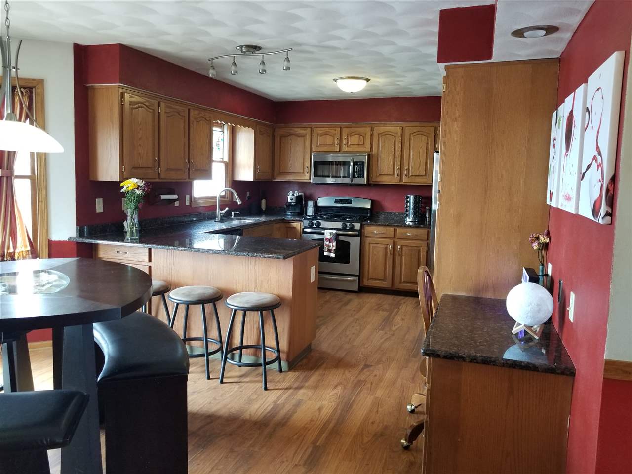 10972 Smith Road Winnebago, IL 61088 - Photo 8 of 25 a kitchen with a table chairs and a refrigerator