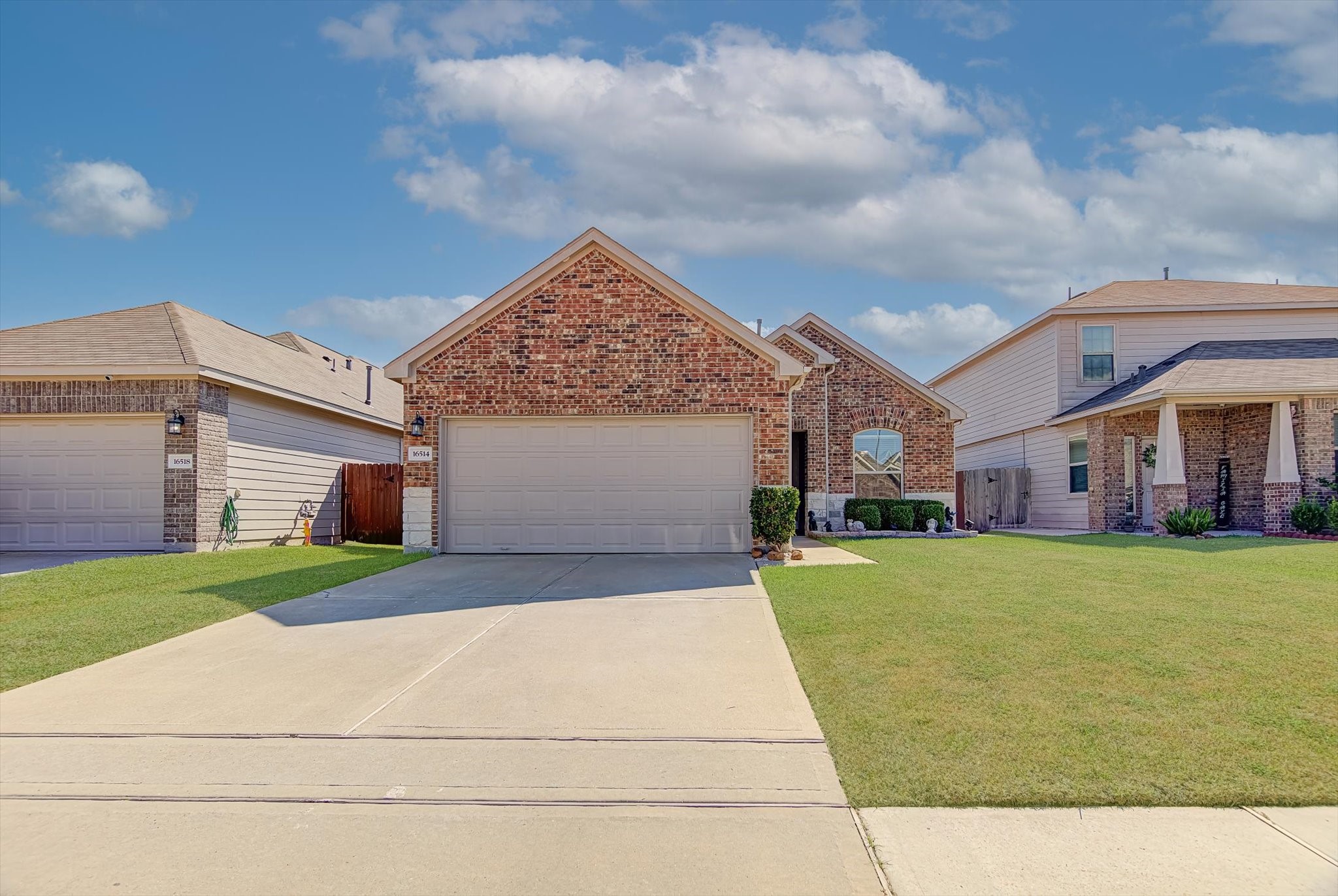 16514 Twinwalker Drive Houston, TX 77049 - Photo 2 of 35 a front view of a house with a yard and garage