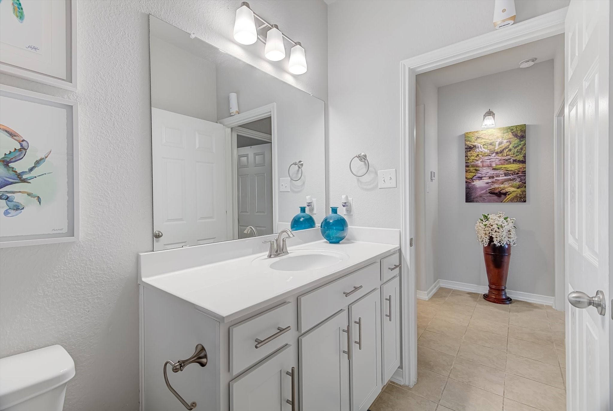 16514 Twinwalker Drive Houston, TX 77049 - Photo 21 of 35 a bathroom with a sink and a mirror