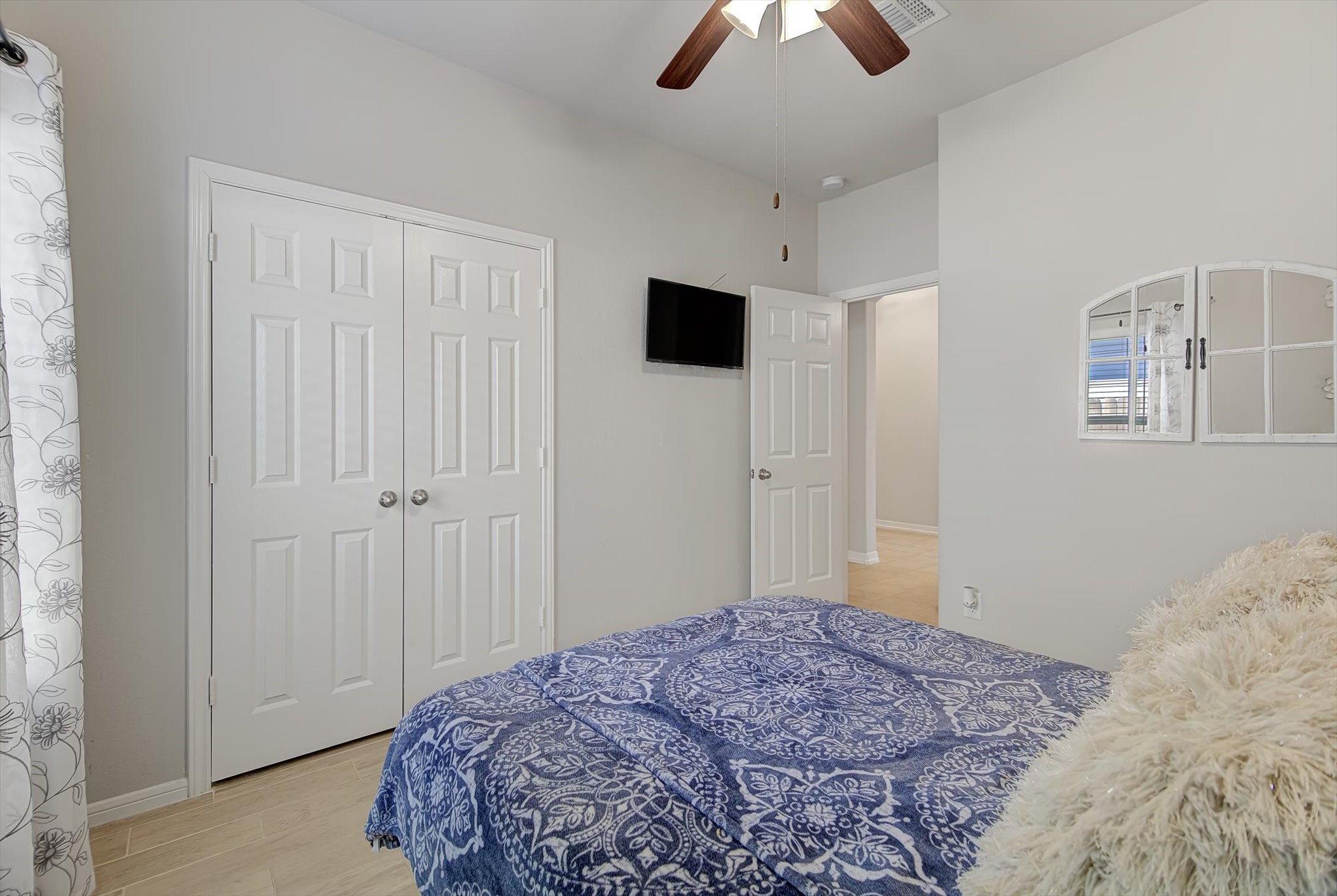 16514 Twinwalker Drive Houston, TX 77049 - Photo 25 of 35 a bedroom with a bed and a chandelier fan