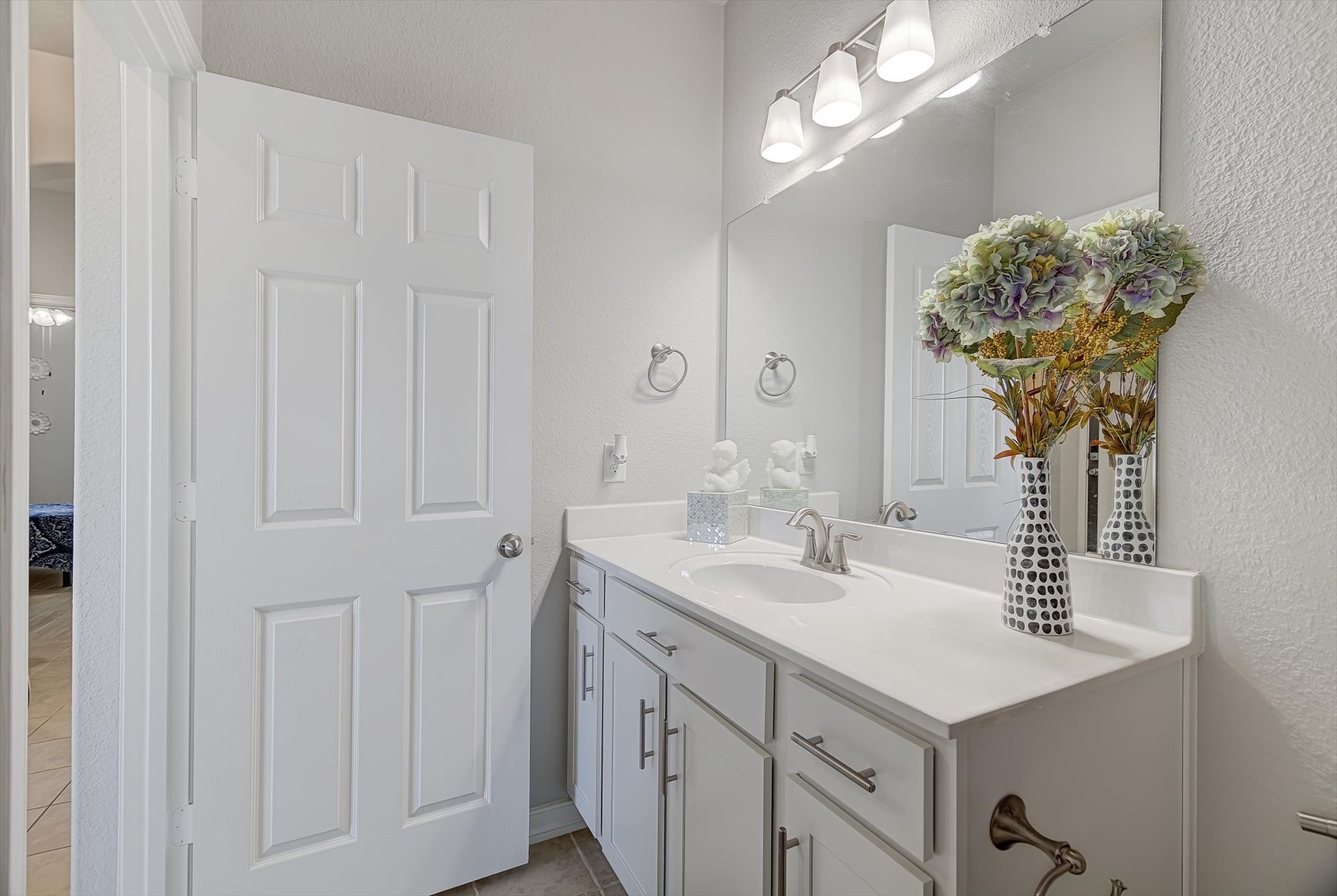 16514 Twinwalker Drive Houston, TX 77049 - Photo 28 of 35 a bathroom with a sink a vanity and a mirror