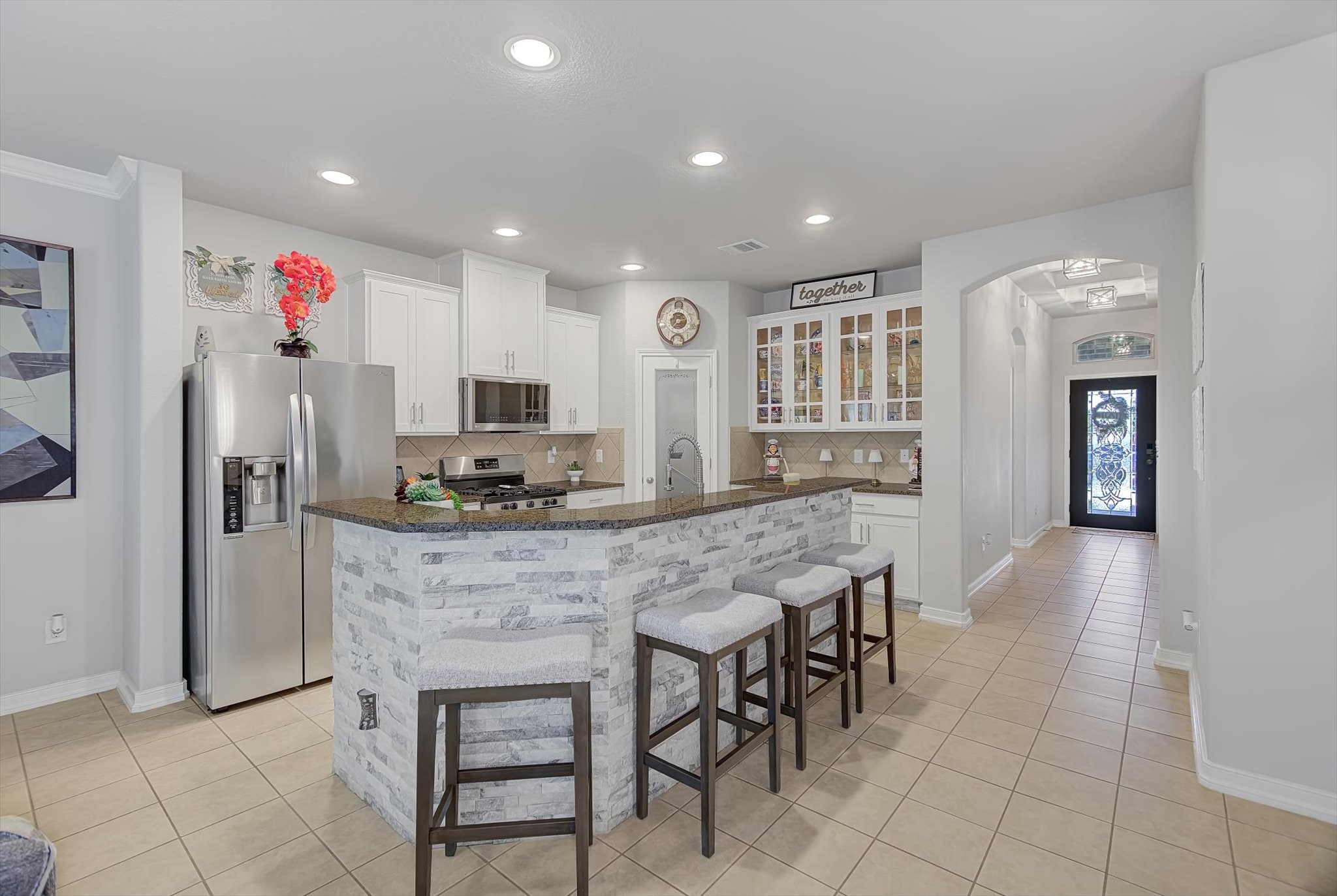 16514 Twinwalker Drive Houston, TX 77049 - Photo 8 of 35 a kitchen with kitchen island granite countertop wooden cabinets and stainless steel appliances