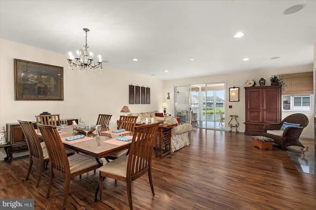 a living room with furniture a wooden floor and a flat screen tv