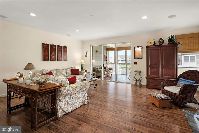 a living room with furniture and kitchen view
