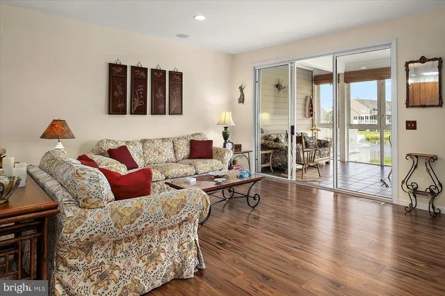a living room with furniture and kitchen view