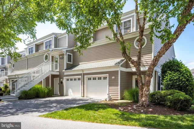 an aerial view of a house with a garden and lake view