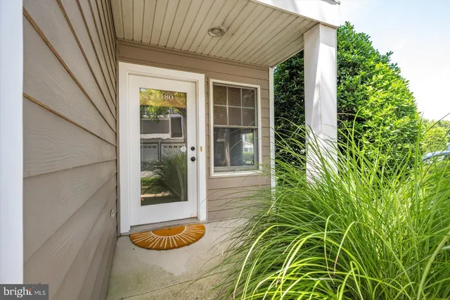 a living room with furniture a wooden floor and a flat screen tv