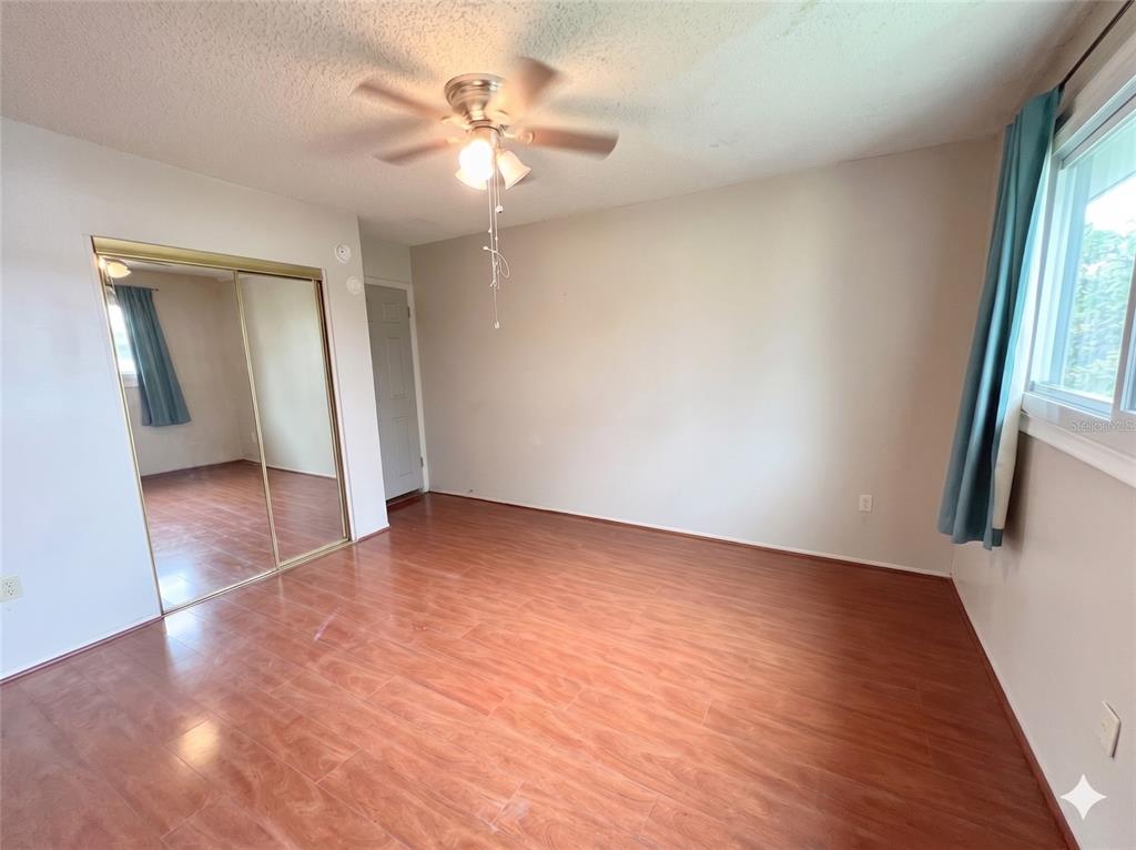 912 Lake Destiny Road, Unit F Altamonte Springs, FL 32714 - Photo 6 of 12 wooden floor in an empty room with a window