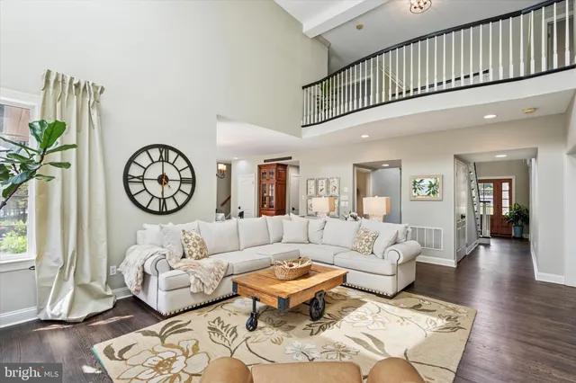 a living room with furniture a table and a clock