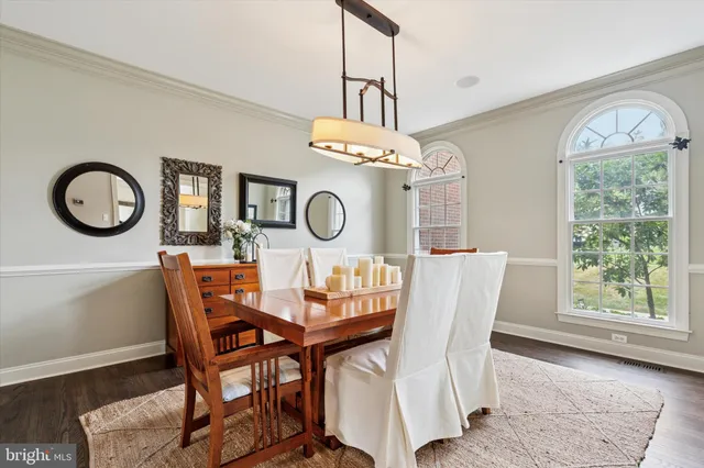 a view of a dining room with furniture and a large window