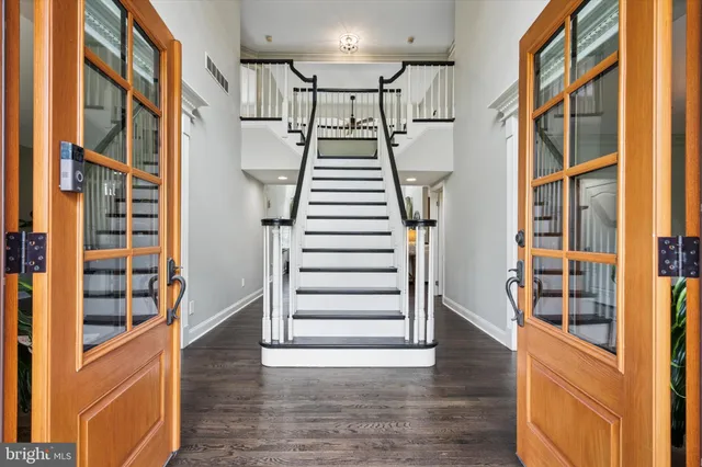 a view of an entryway with wooden floor and windows