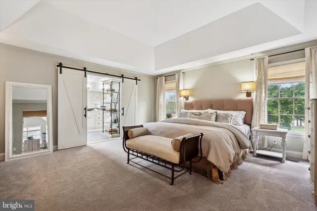 a spacious bedroom with a bed and large window