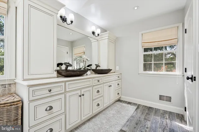 a kitchen with cabinets and window